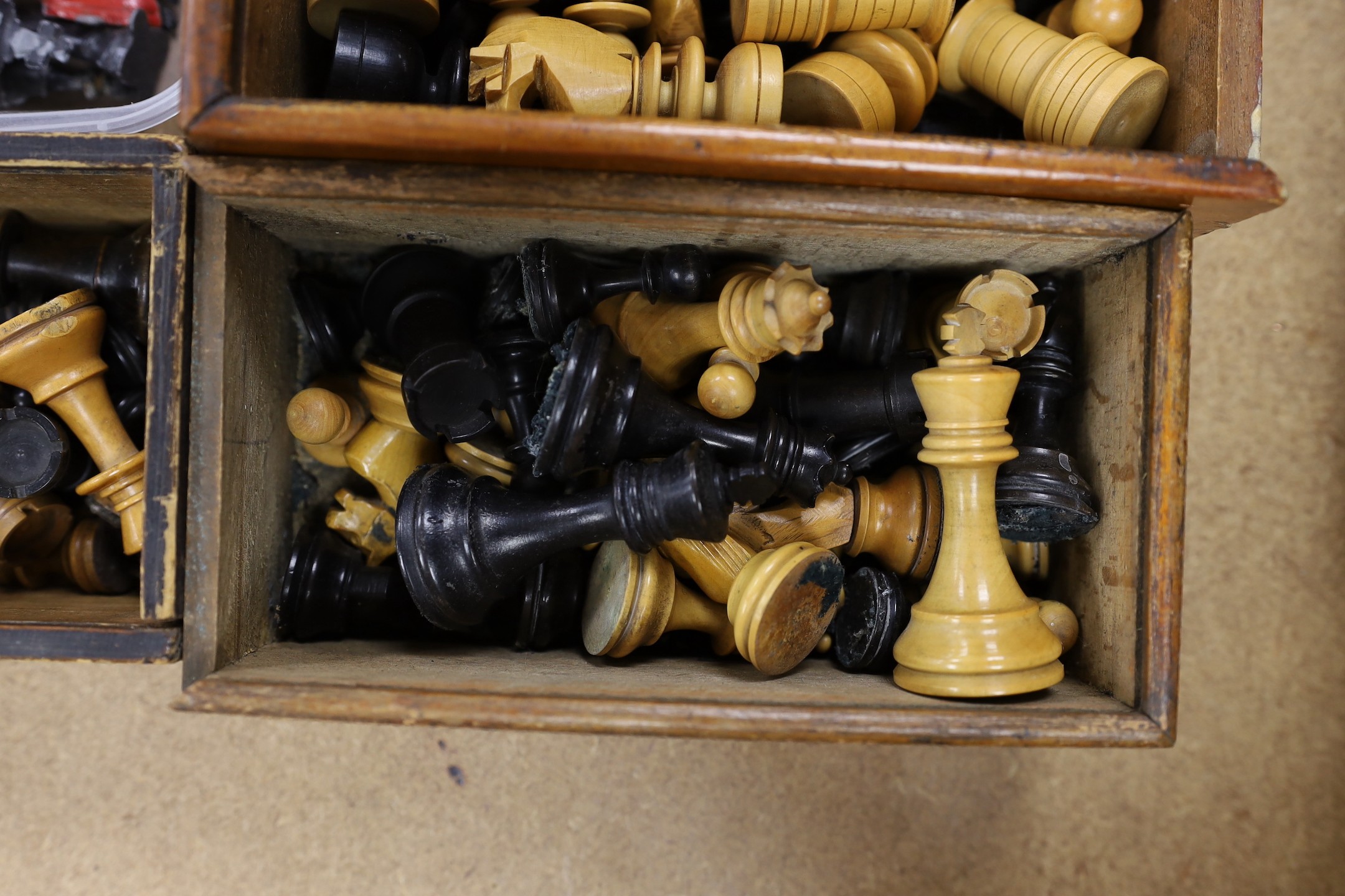 A painted lead chess set together with three boxed turned wooded chess sets.